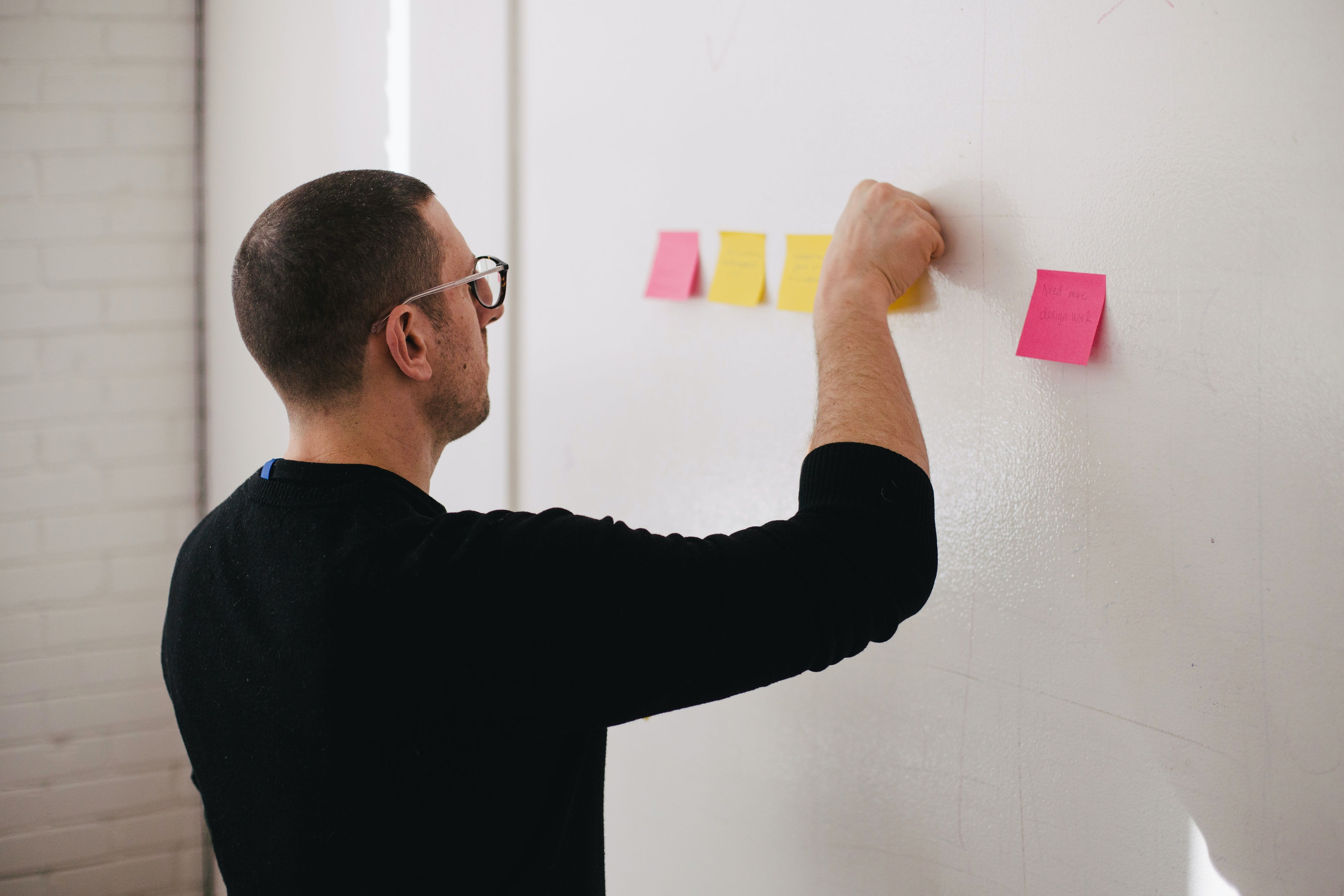 Man brainstorming ideas with sticky notes
