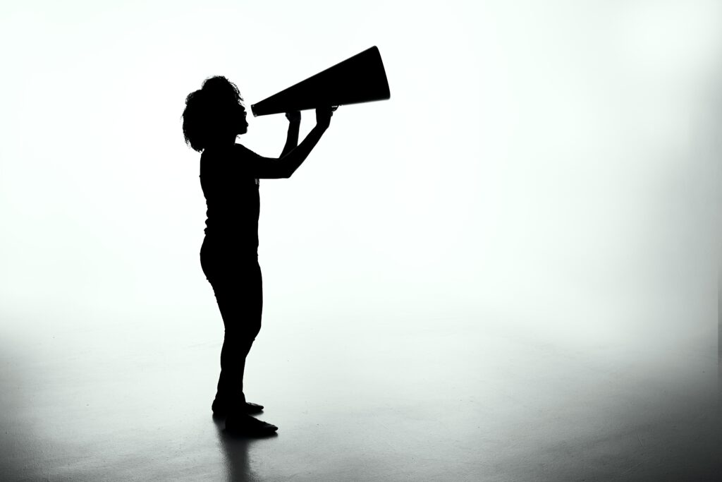 Woman shouting into a megaphone